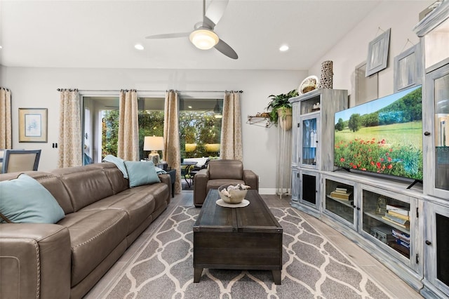 living room featuring ceiling fan and light wood-type flooring