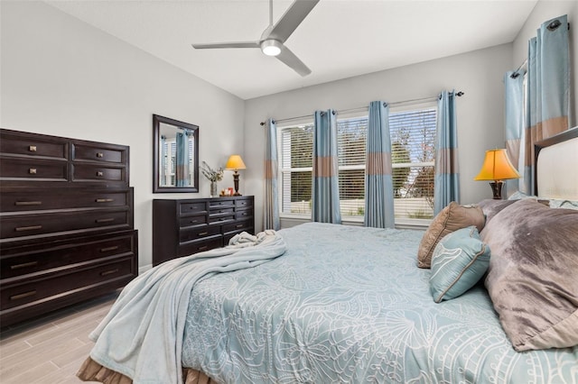 bedroom with light hardwood / wood-style flooring and ceiling fan