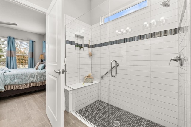 bathroom with a shower with door and wood-type flooring