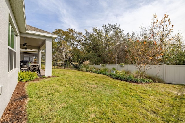 view of yard with ceiling fan