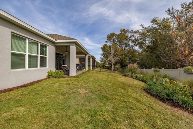 view of yard with ceiling fan