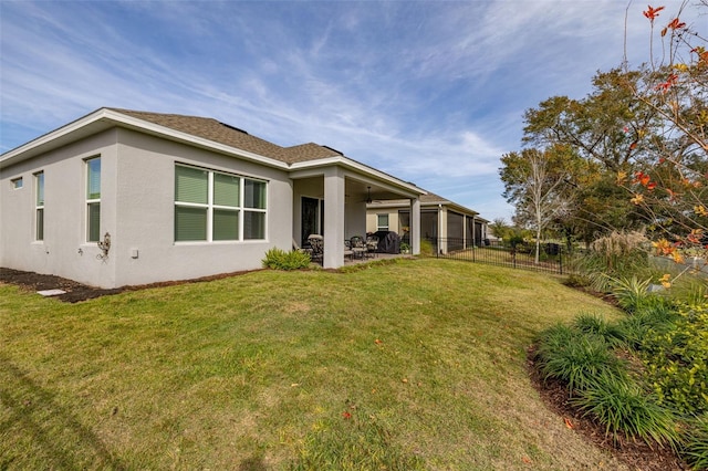 rear view of house with a yard and a patio area