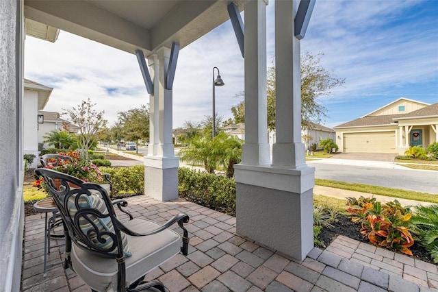 view of patio featuring a garage and covered porch