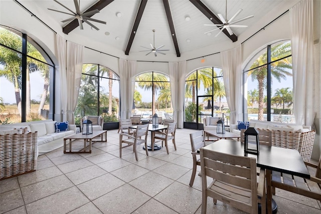 sunroom featuring lofted ceiling with beams and ceiling fan