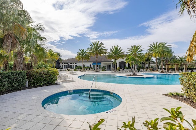 view of pool featuring a patio and a community hot tub