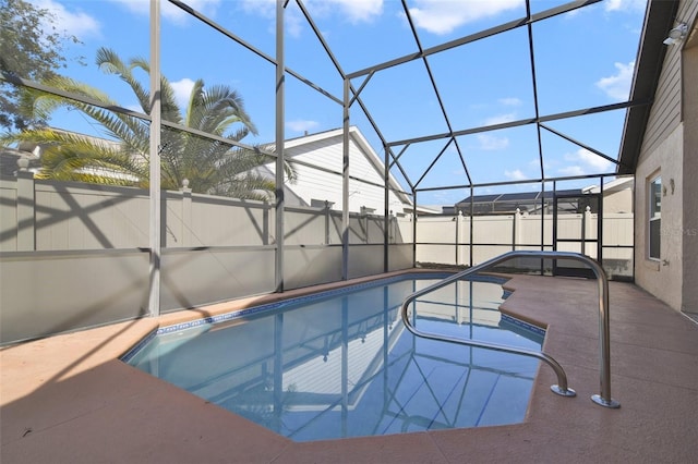 view of swimming pool featuring a lanai and a patio area