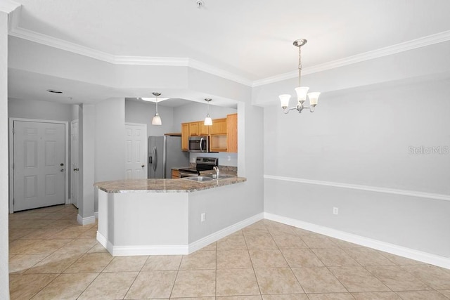 kitchen with pendant lighting, ornamental molding, appliances with stainless steel finishes, and light tile patterned flooring