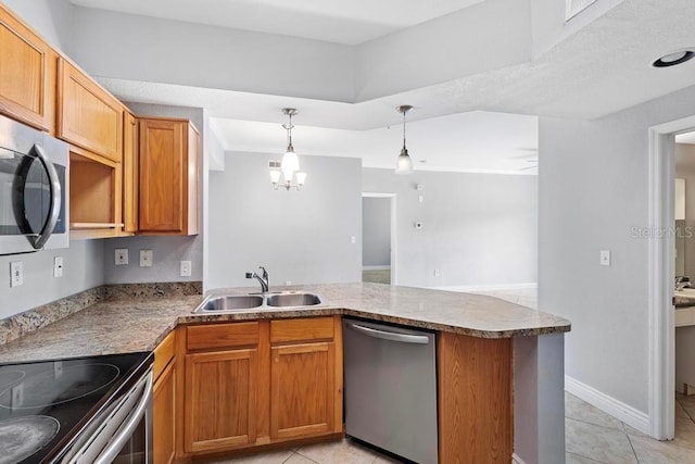 kitchen featuring appliances with stainless steel finishes, decorative light fixtures, sink, kitchen peninsula, and light tile patterned floors