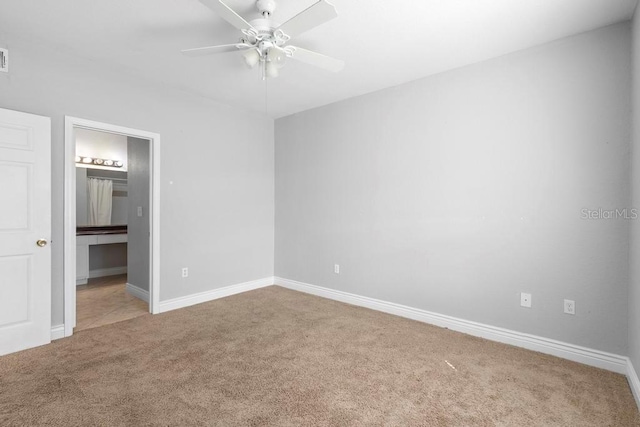 unfurnished bedroom featuring carpet, ensuite bath, and ceiling fan