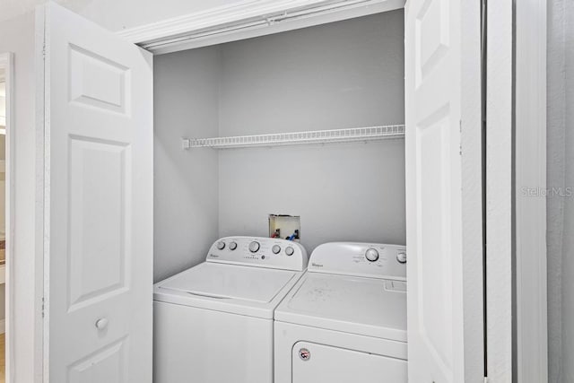 washroom with independent washer and dryer