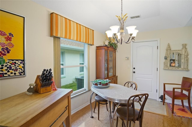 dining area featuring a chandelier and light hardwood / wood-style floors