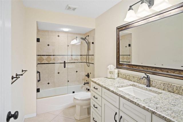 full bathroom featuring toilet, tile patterned floors, shower / bath combination with glass door, and vanity