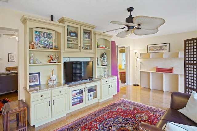 living room featuring ceiling fan and light wood-type flooring