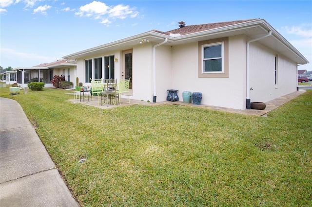 exterior space featuring a lawn and a patio