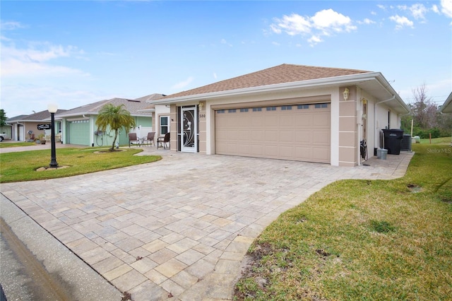 ranch-style house featuring a garage and a front yard