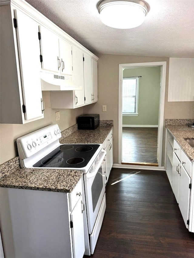 kitchen featuring dark hardwood / wood-style floors, white electric range, white cabinetry, dark stone counters, and a textured ceiling