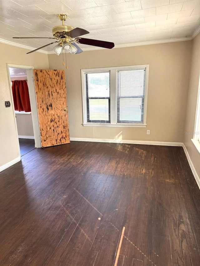 unfurnished room with baseboards, ceiling fan, wood finished floors, and crown molding