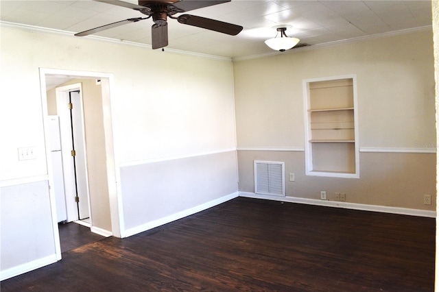 empty room featuring visible vents, crown molding, and wood finished floors