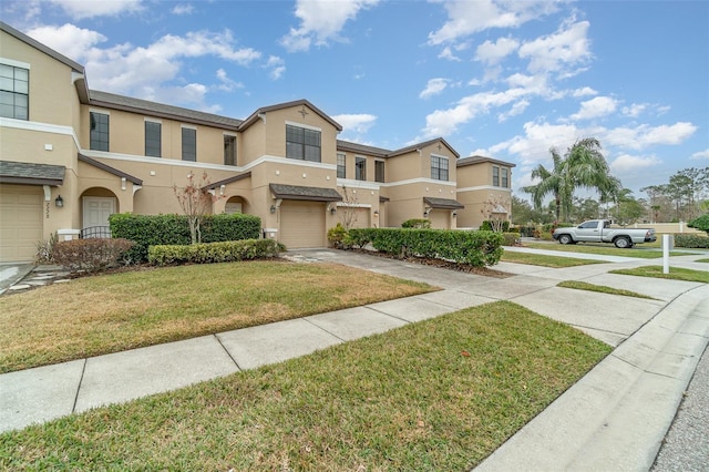 view of property featuring a front lawn