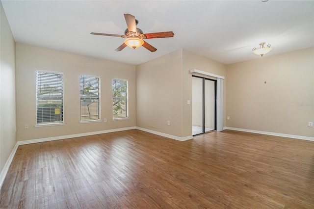 empty room with hardwood / wood-style floors and ceiling fan