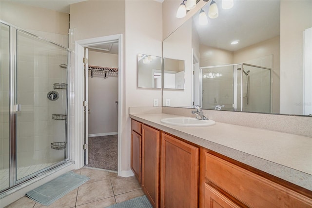 bathroom with tile patterned flooring, an enclosed shower, and vanity