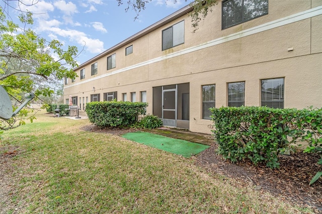 rear view of property featuring a yard