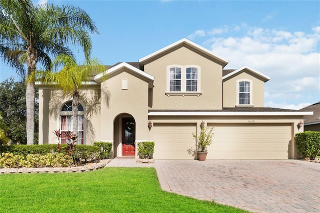 view of front of home featuring a garage and a front lawn