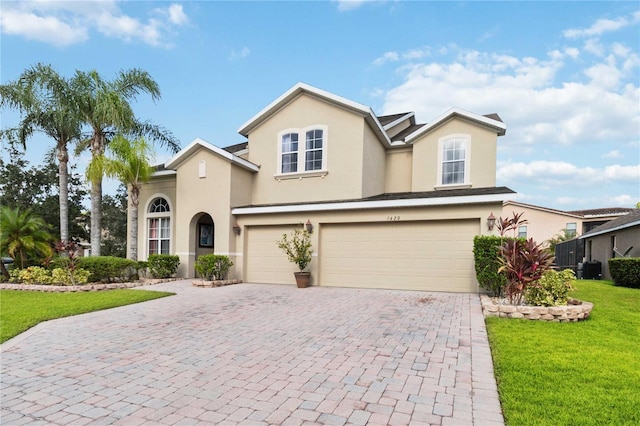 view of front facade with a garage and a front lawn