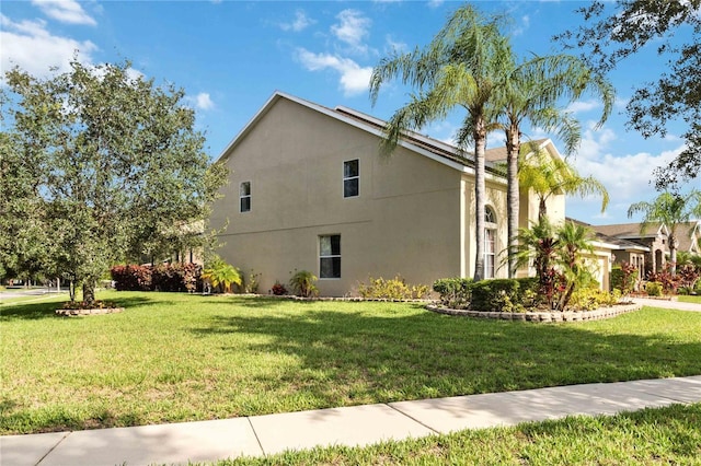 view of side of home featuring a lawn