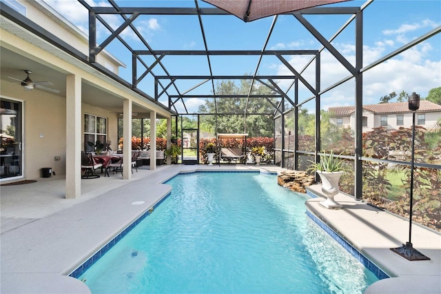 view of pool with ceiling fan, a lanai, and a patio area