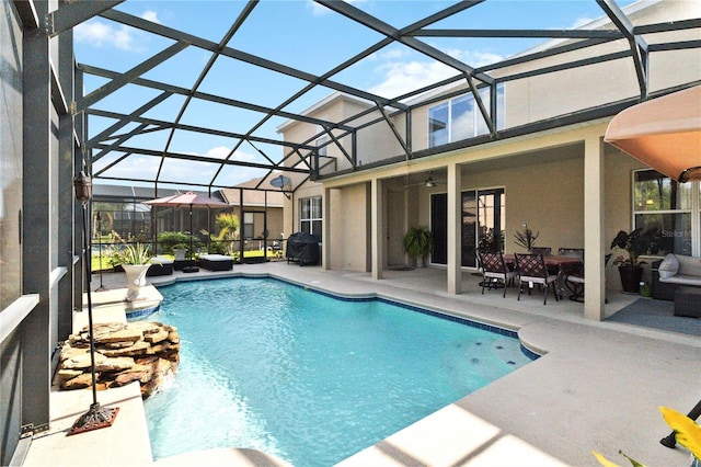 view of pool featuring a patio area and glass enclosure