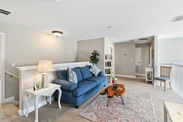 carpeted living room with a textured ceiling