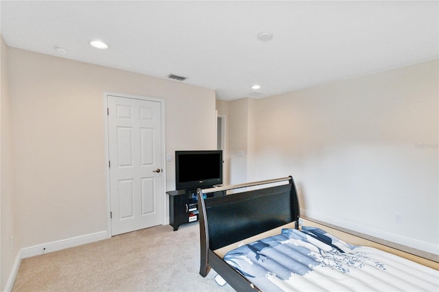 bedroom featuring light carpet