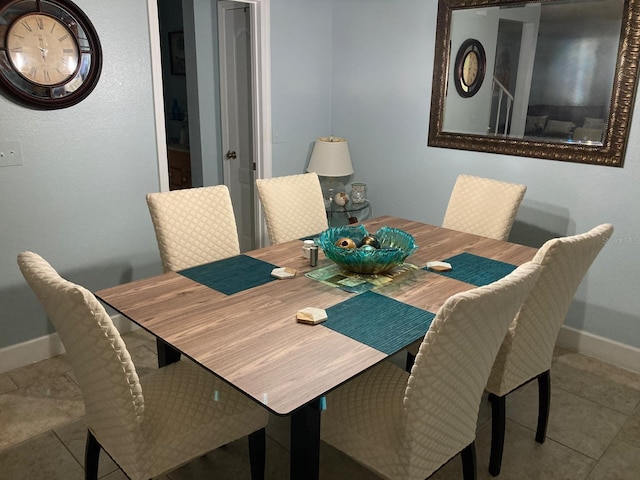 dining space featuring light tile patterned flooring