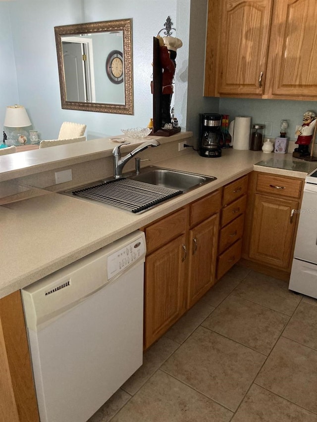 kitchen with sink, light tile patterned flooring, stove, and white dishwasher