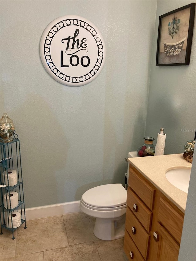 bathroom featuring tile patterned floors, toilet, and vanity