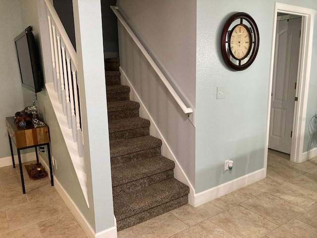 stairs with tile patterned flooring