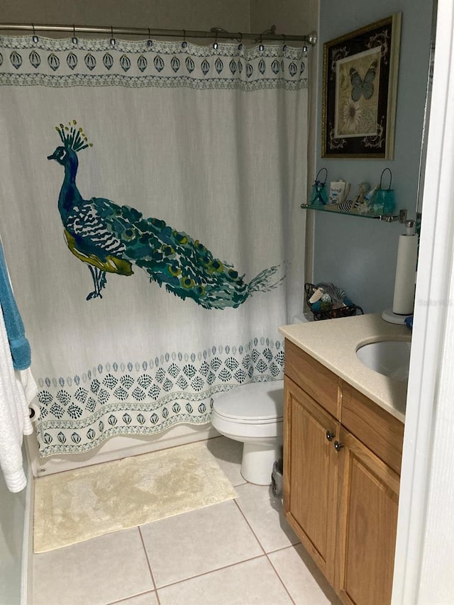 bathroom featuring vanity, toilet, and tile patterned flooring