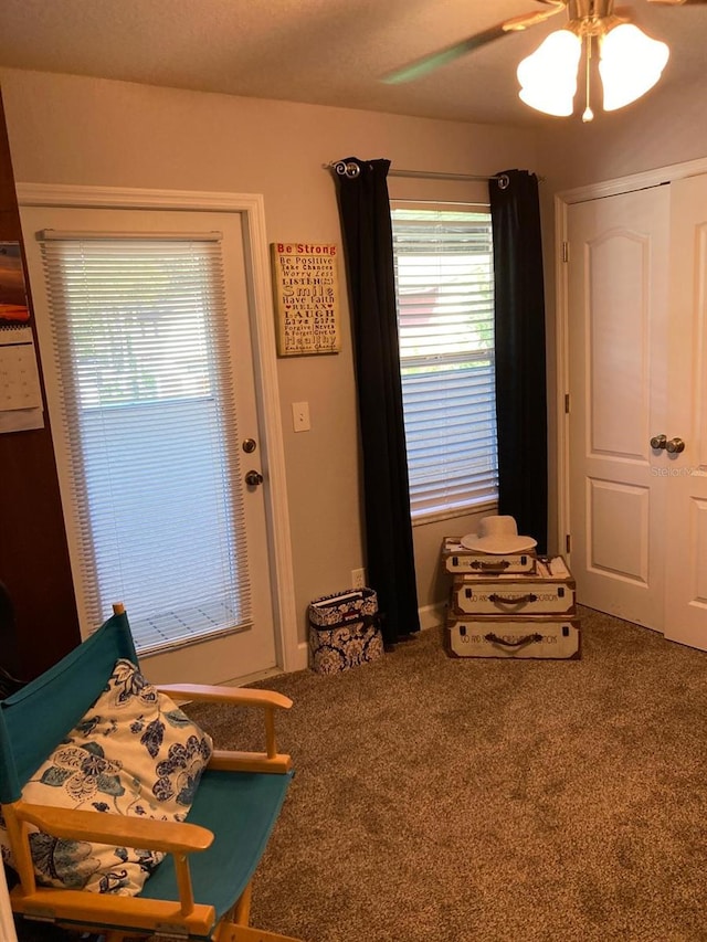 sitting room featuring ceiling fan and carpet flooring