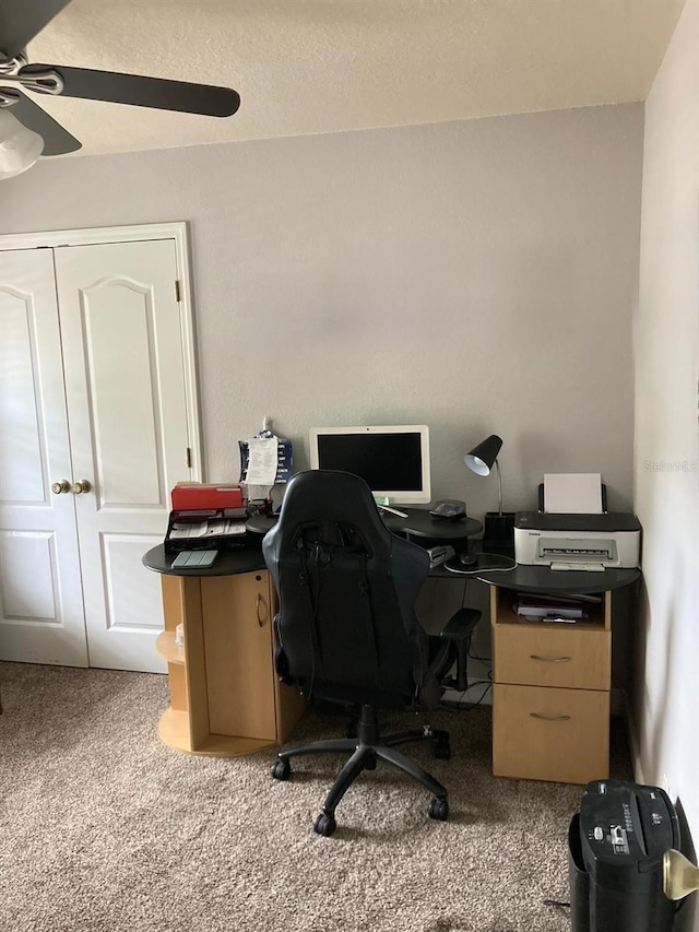 home office featuring ceiling fan and carpet