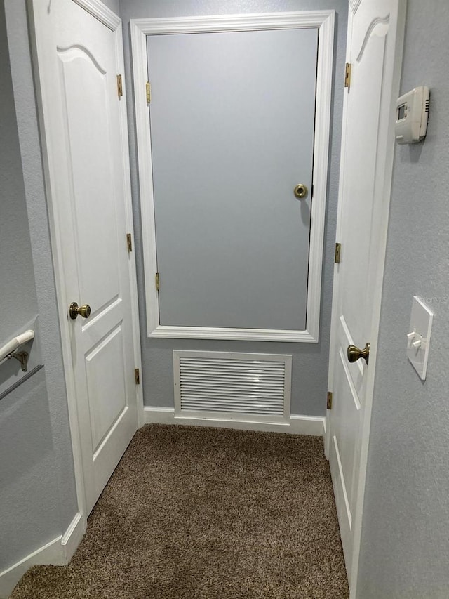 interior space featuring dark colored carpet