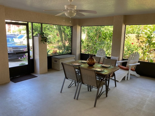 sunroom / solarium featuring ceiling fan