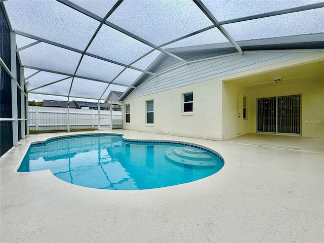 view of swimming pool with a patio area and a lanai