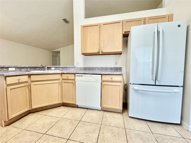 kitchen with white appliances, light brown cabinetry, light tile patterned floors, and lofted ceiling