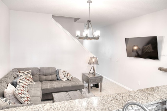 living room with light tile patterned floors and a notable chandelier