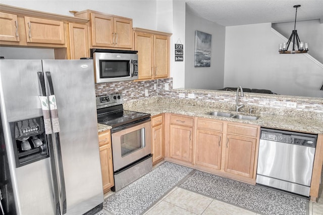 kitchen featuring sink, light brown cabinets, light tile patterned floors, stainless steel appliances, and light stone countertops