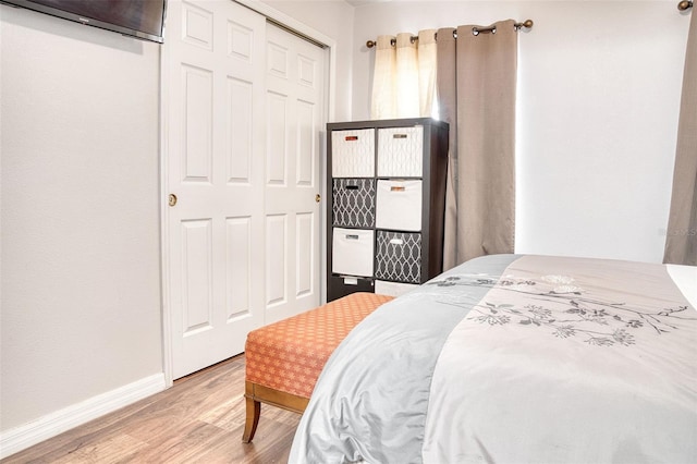 bedroom featuring light hardwood / wood-style floors and a closet