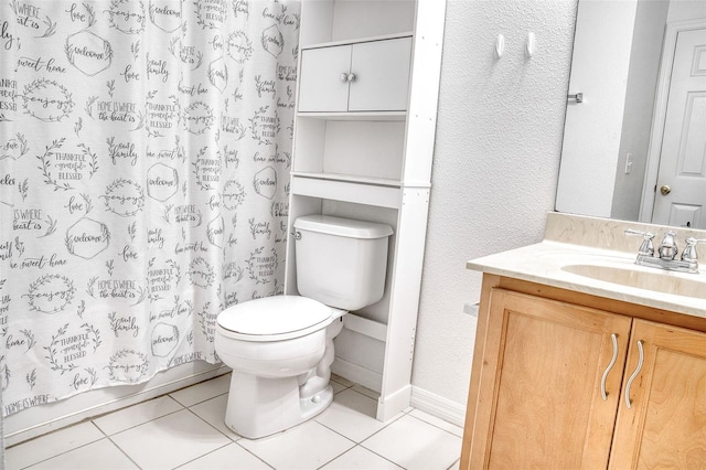 bathroom with vanity, toilet, and tile patterned flooring