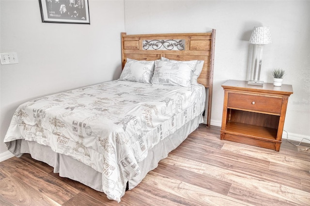 bedroom with hardwood / wood-style floors