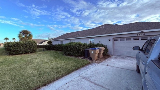 view of home's exterior featuring a lawn and a garage